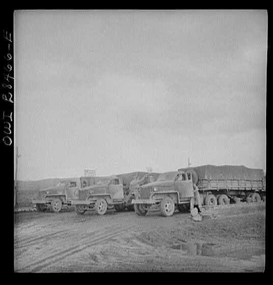 Somewhere in the Persian corridor. A United States Army truck convoy carrying supplies for Russia at a petrol point.