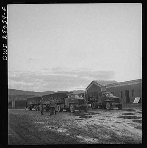 Somewhere in the Persian corridor. A United States Army truck convoy carrying supplies for Russia at a fueling point.