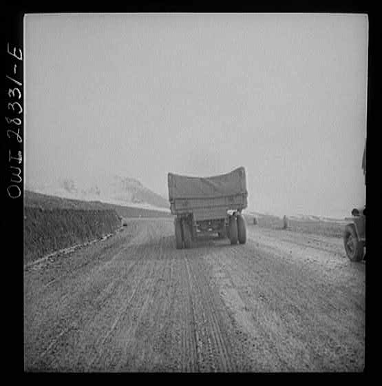 Somewhere in the Persian corridor. A United States Army truck convoy carrying supplies for the aid of Russia climbing a mountain road over the Iranian mountains.