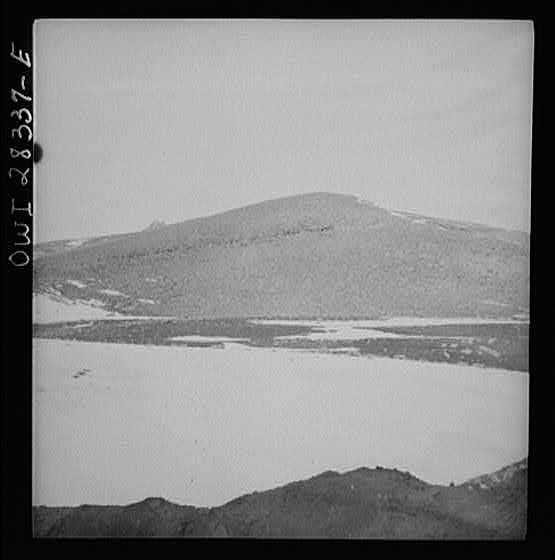 Somewhere in the Persian corridor. A United States Army truck convoy carrying supplies for the aid of Russia. Just below the top of the mountain climbing the steep grade.