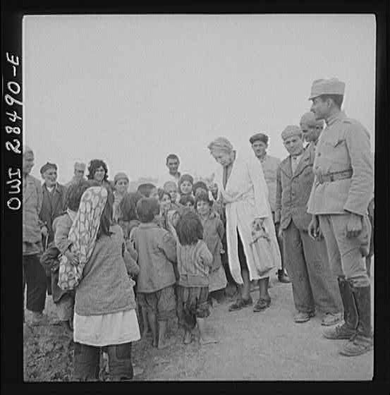 Teheran, Iran. Mrs. Louis Dreyfus, wife of the United States Minister to Iran, talking with native children