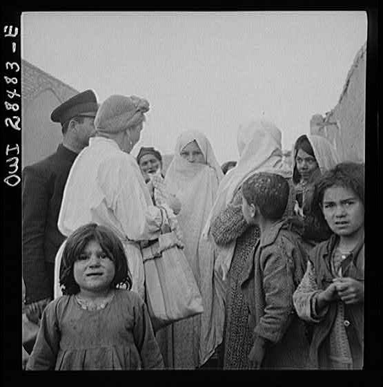 Teheran, Iran. Mrs. Louis Dreyfus, wife of the United States Minister to Iran, visiting in the poorer section of the city.