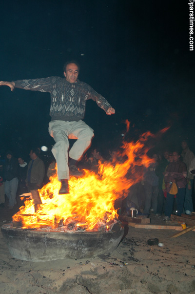 Man jumping over the bonfire (March 14, 2006) - by QH