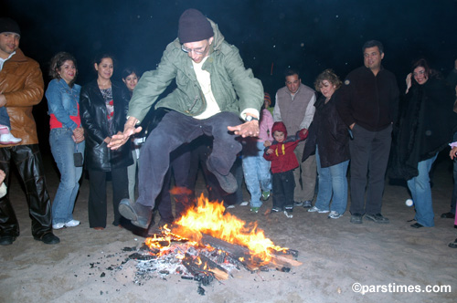 Man jumping over the bonfire (March 14, 2006) - by QH