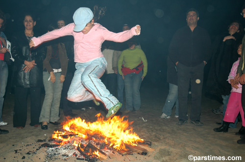 Man jumping over the bonfire (March 14, 2006) - by QH