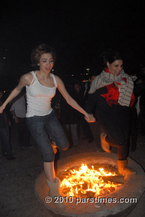 Woman jumping over fire (March 15, 2011) - by QH