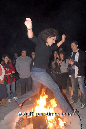 Woman jumping over fire (March 15, 2011) - by QH