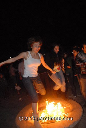 Woman jumping over fire (March 15, 2011) - by QH