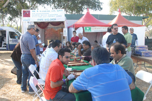 People having 
fun playing backgammon - by QH