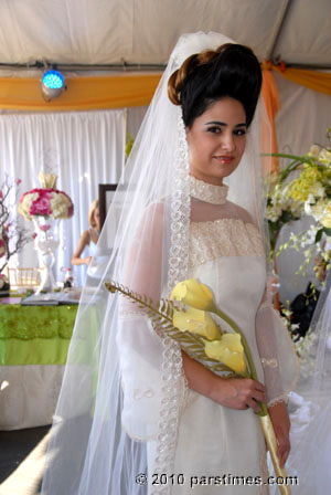 Young bride in her wedding gown - by QH