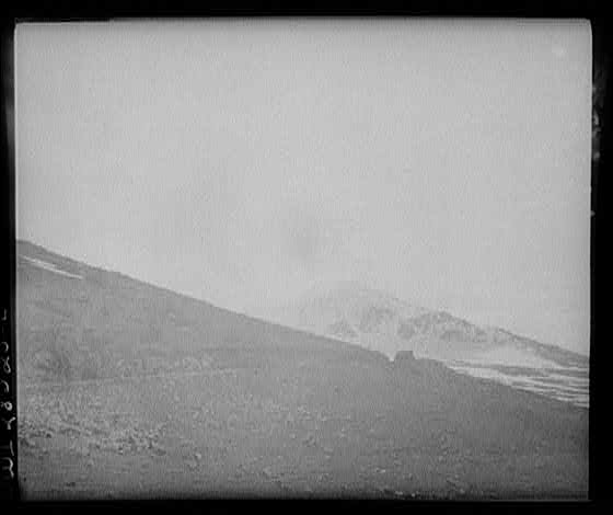 Somewhere in the Persian corridor. A United States Army truck convoy carrying supplies for Russia on a ledge of a rocky mountain.