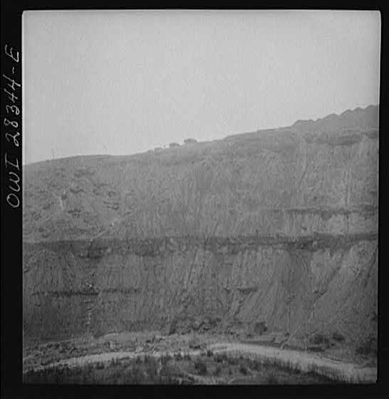 Somewhere in the Persian corridor. A United States Army truck convoy carrying supplies for Russia moving on the edge of a rocky mountain.