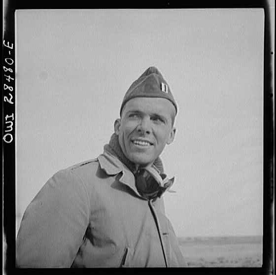 Somewhere in the Persian corridor. A United States Army truck convoy carrying supplies for Russia. Captain C.B. Cutler of Chicago, Illinois, dust-covered and wearing sand goggles. The leader of a convoy riding a jeep at the end of the line checking disabled trucks as he passes. A repair crew also moves at the end of a convoy.