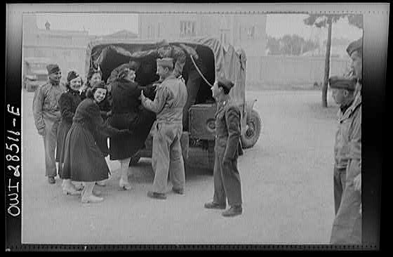 United States Army nurses being helped into the back end of a truck somewhere in Iran